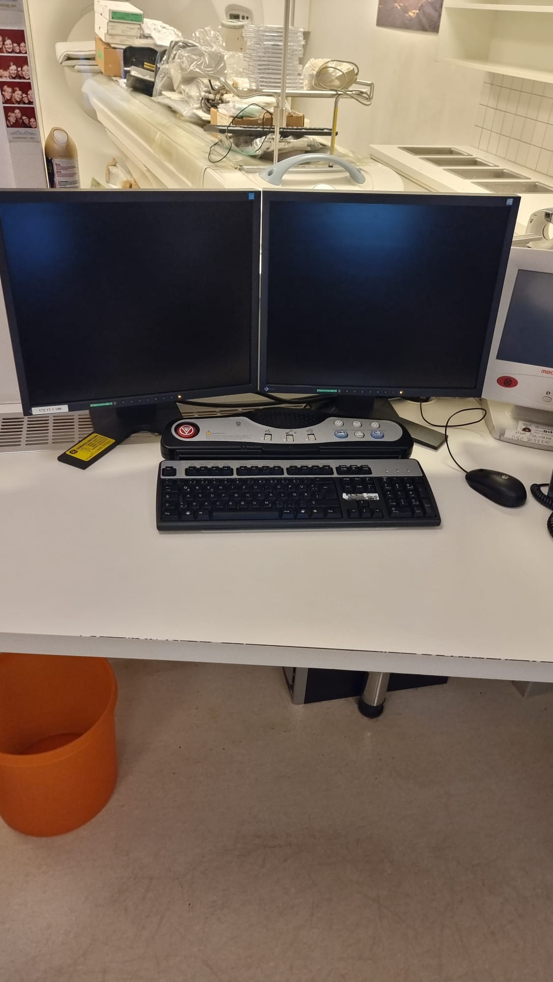 GE Optima CT660 / Optima 660 operator console — dual EIZO diagnostic monitors, tabletop scan controller and keyboard on refurbished operator workstation photographed by MTC in Miami, Florida